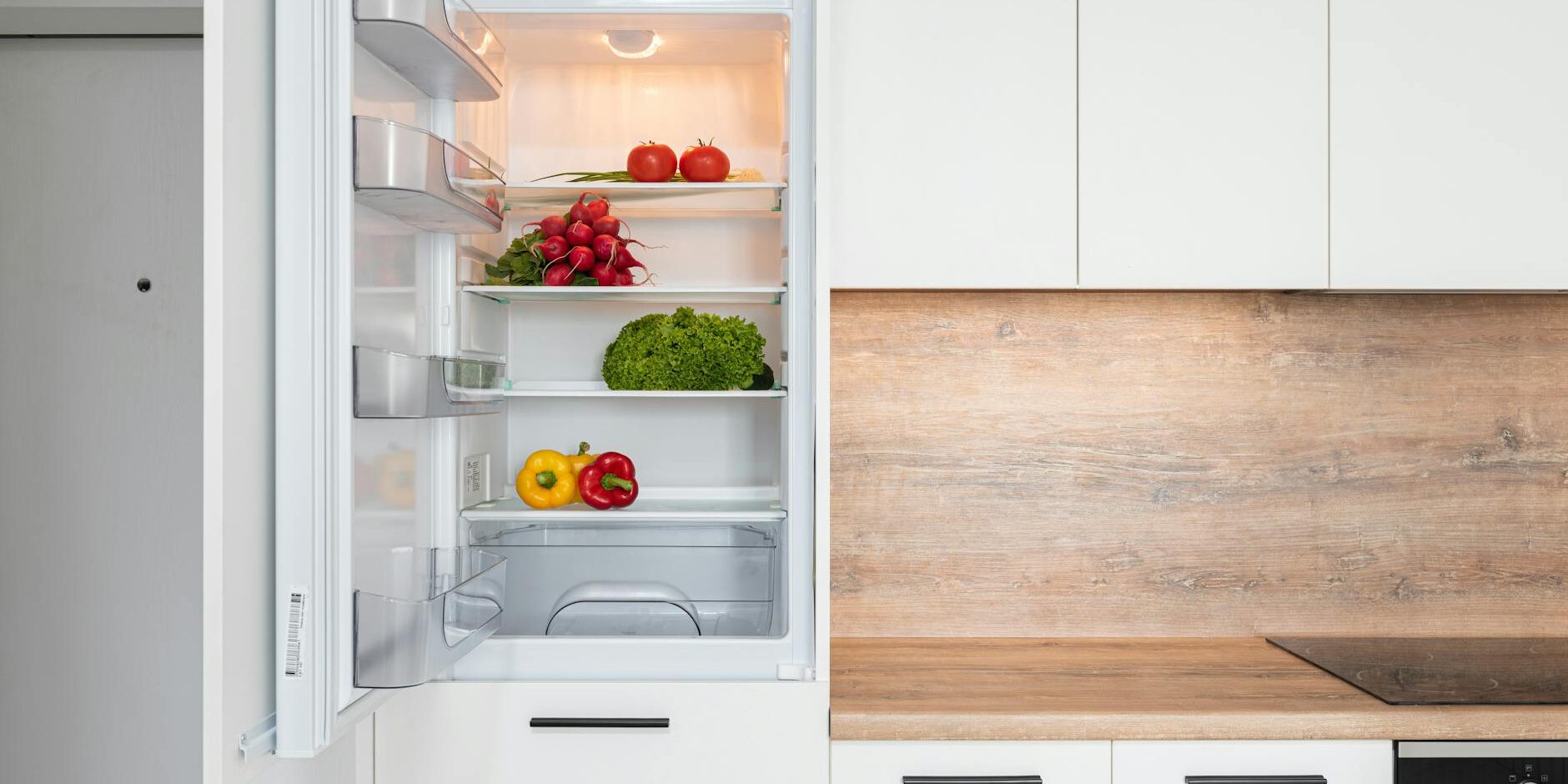 fridge with different vegetable in modern kitchen