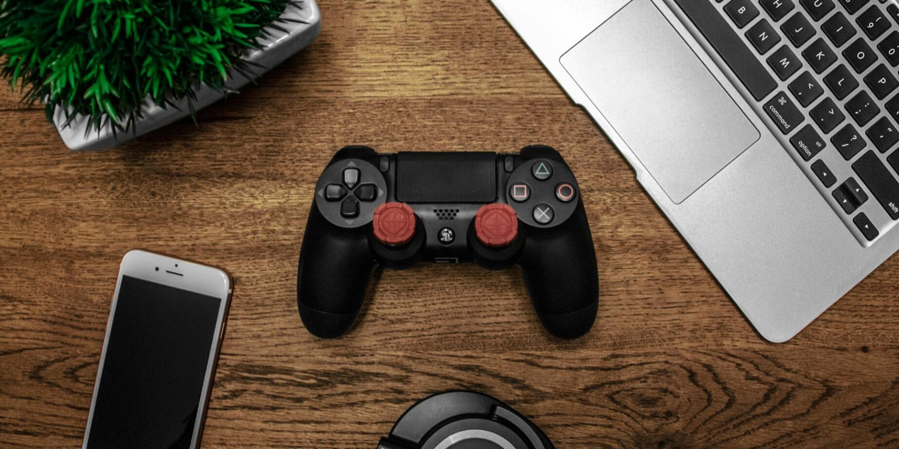 black game console on wooden surface