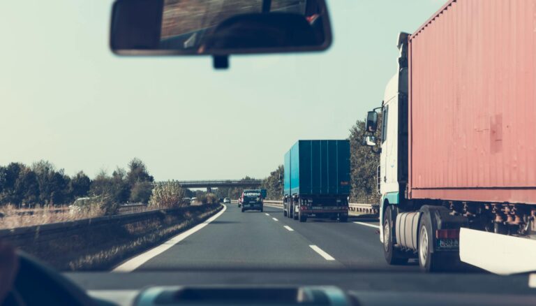 blue and red freight truck on road