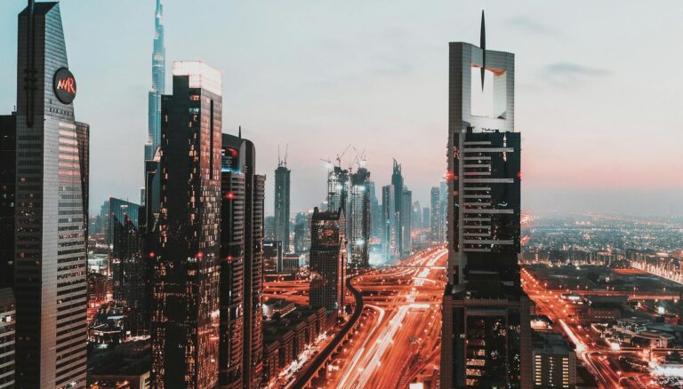 time lapse photography of passing vehicles on city roads