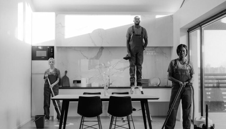 grayscale photo of people standing near table