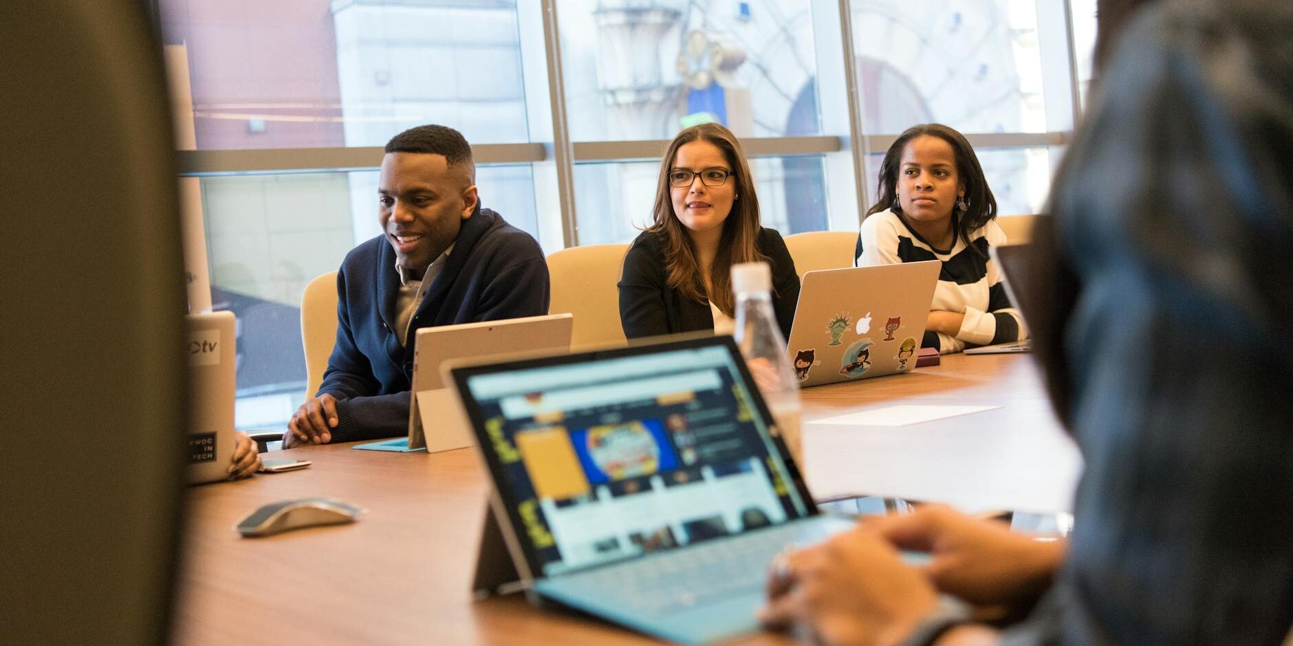 group of people sitting in front of table