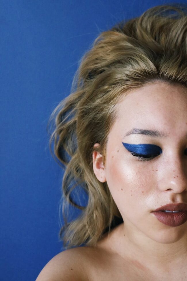 photo of woman with blue eye shadow