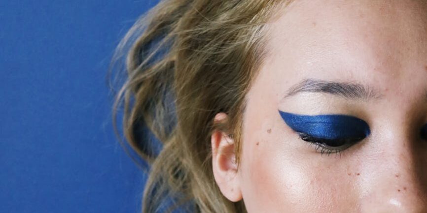 photo of woman with blue eye shadow