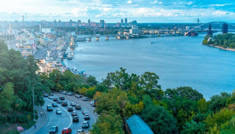 vehicles on road beside sea