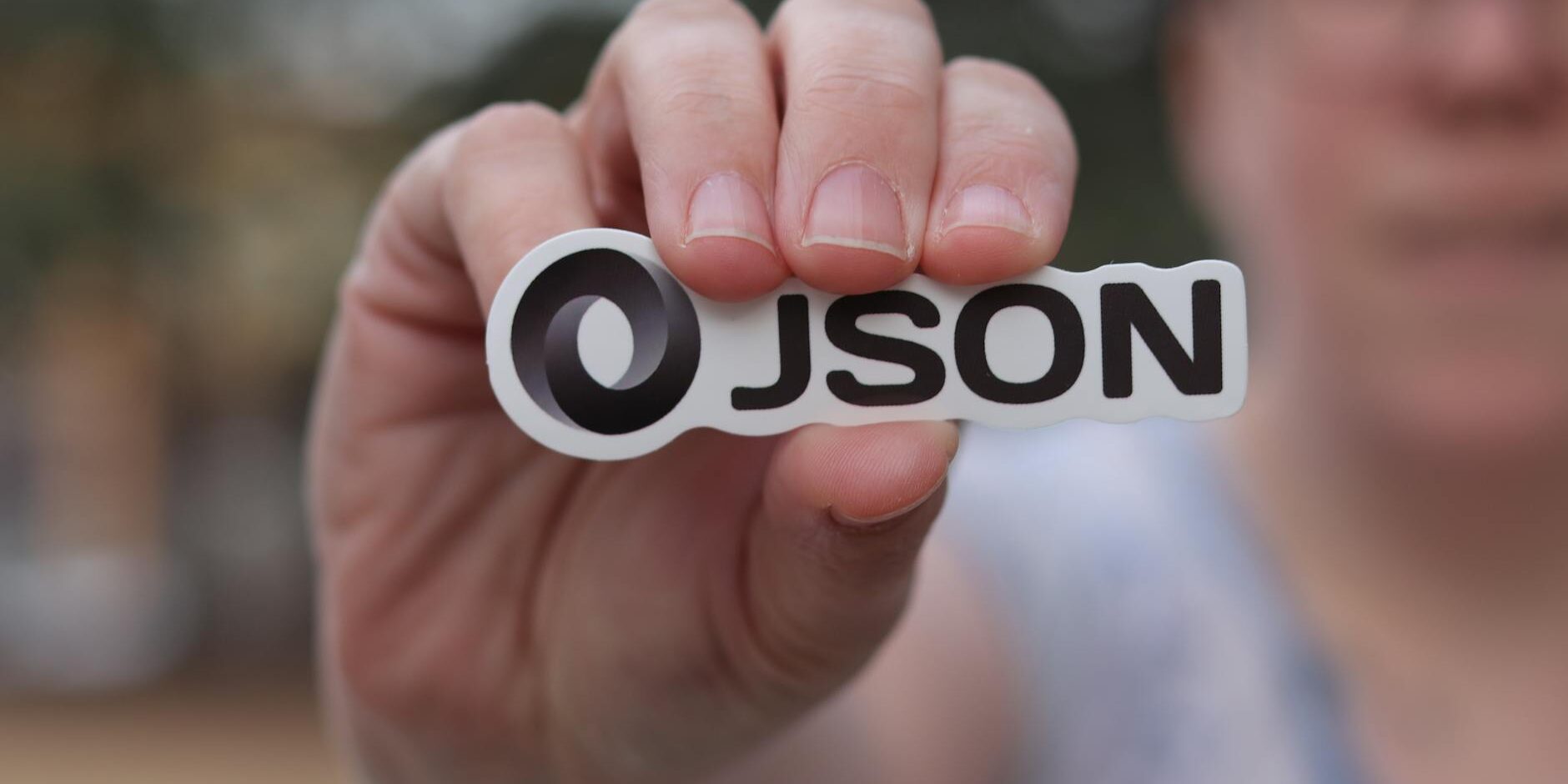 person holding logo of json