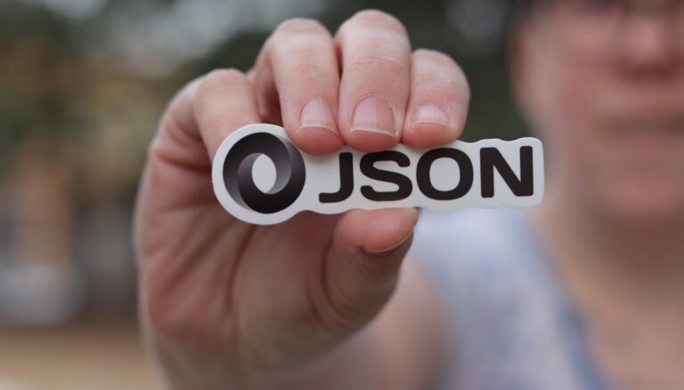 person holding logo of json