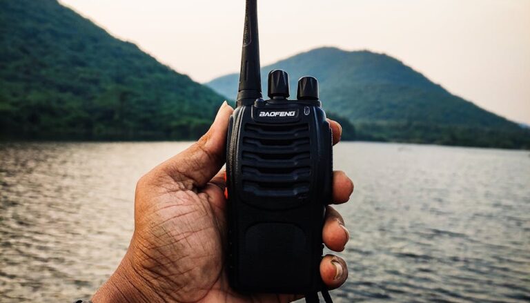person holding a black two way radio
