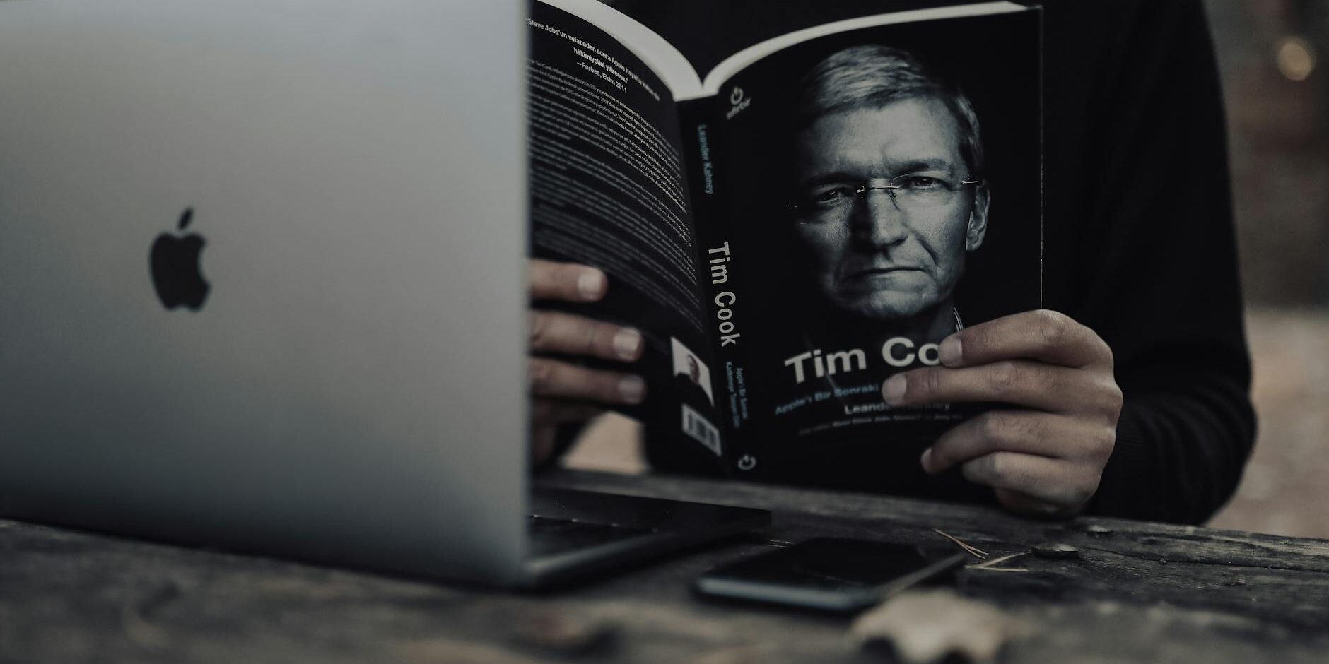 crop man with laptop reading book