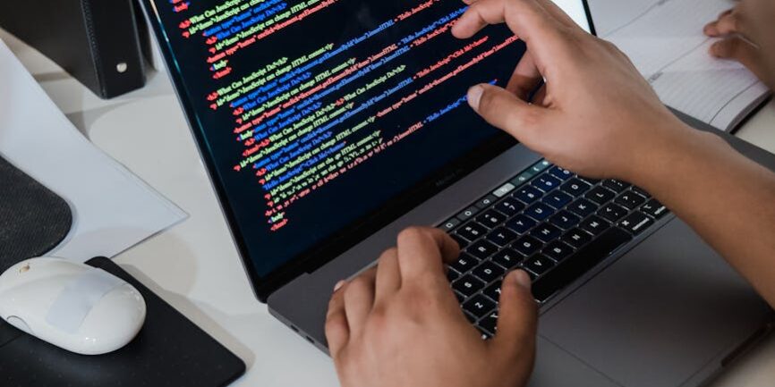 close up of a man pointing code on a laptop screen