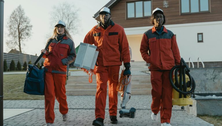 cleaners walking while holding cleaning equipment