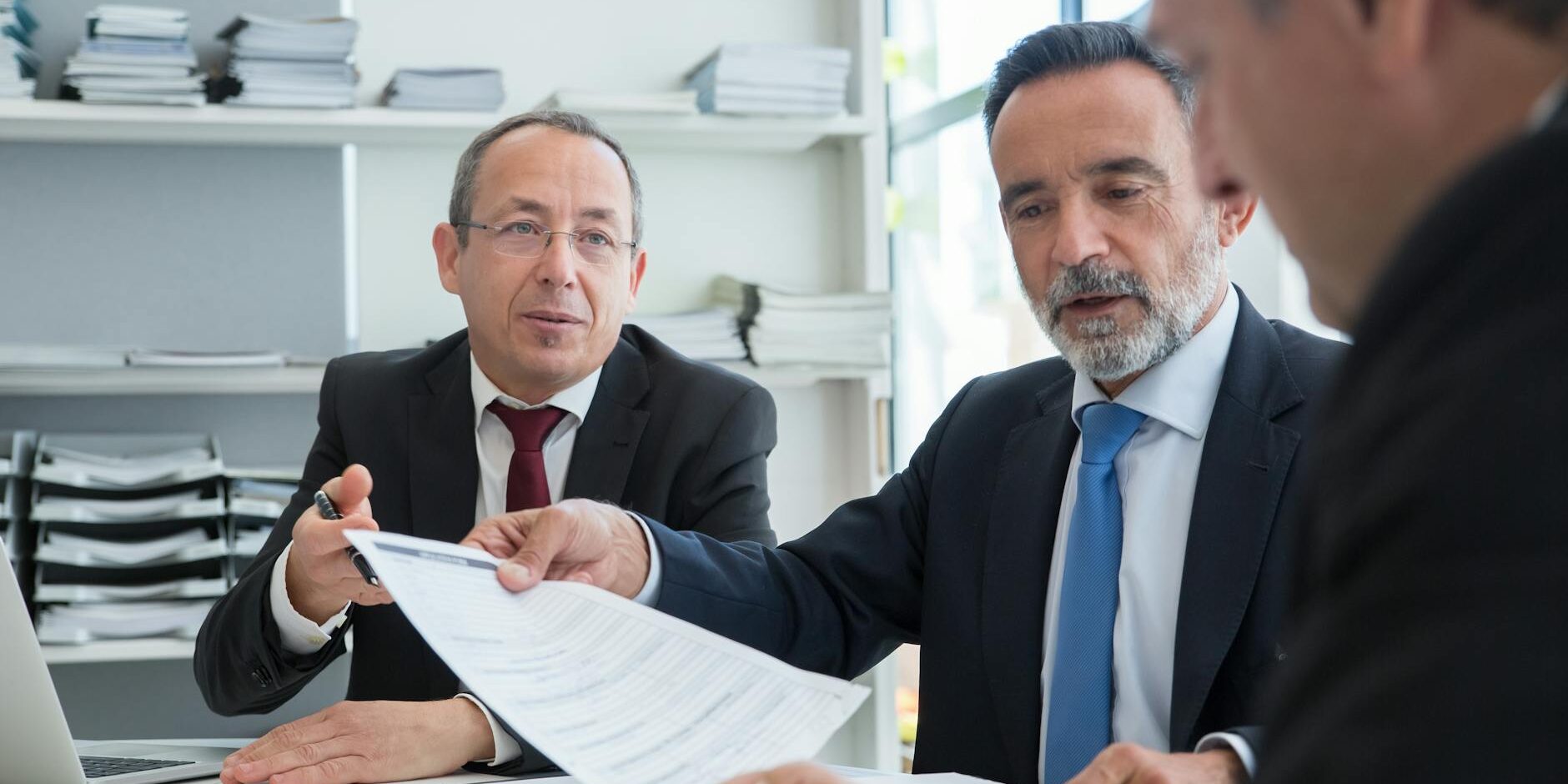 men in black suit having conversation at work