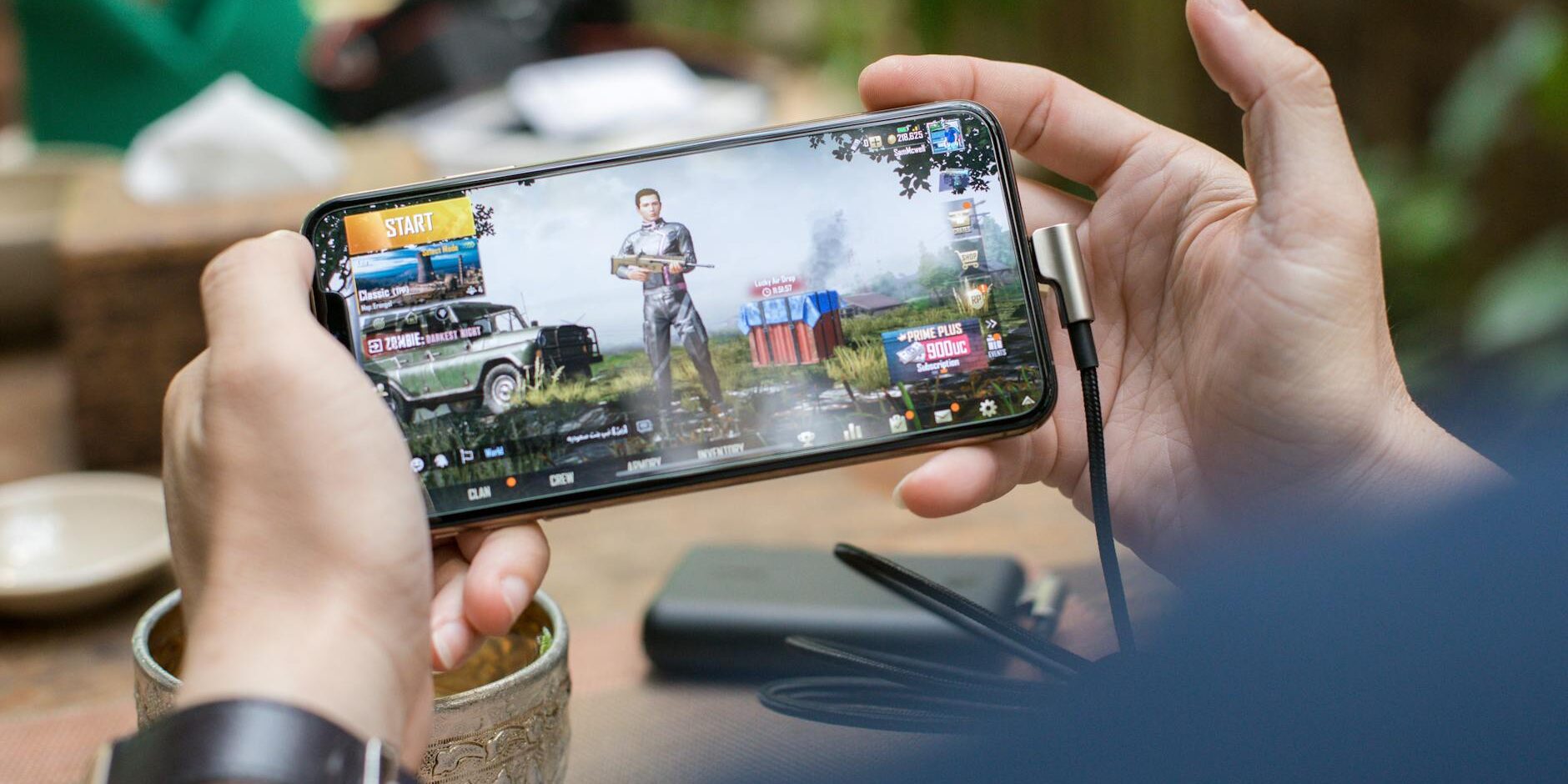 person holding a smartphone playing mobile game