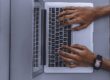 person using laptop on gray table
