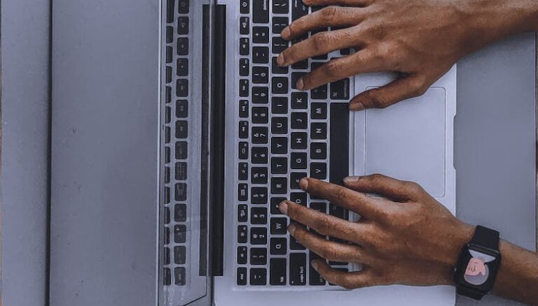 person using laptop on gray table