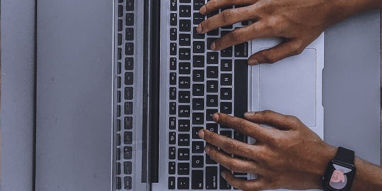 person using laptop on gray table
