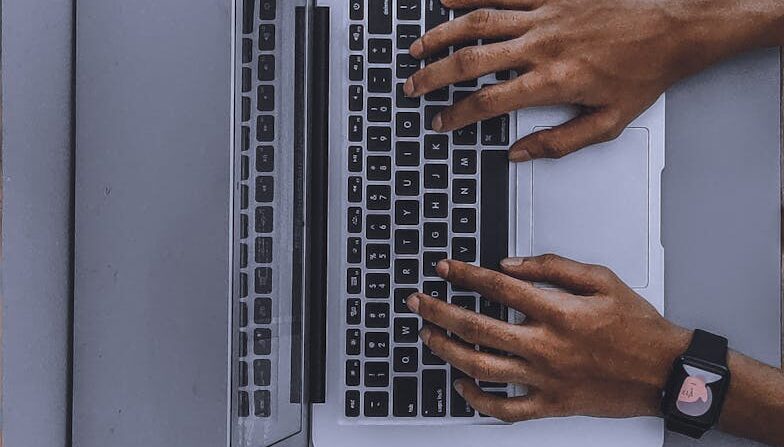 person using laptop on gray table