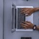 person using laptop on gray table