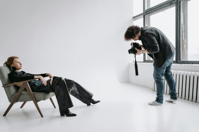 model reclining on a chair at a photo session