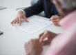 elegant man signing documents