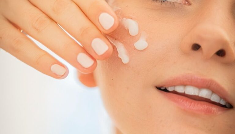 woman applying moisturizer to face close up