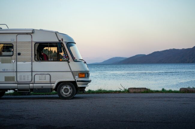 rv vehicle on lakeshore at dusk