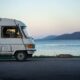 rv vehicle on lakeshore at dusk