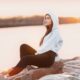 woman in gray hoodie sitting on rock