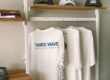 cafe merchandise display with t shirts and caps