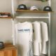 cafe merchandise display with t shirts and caps